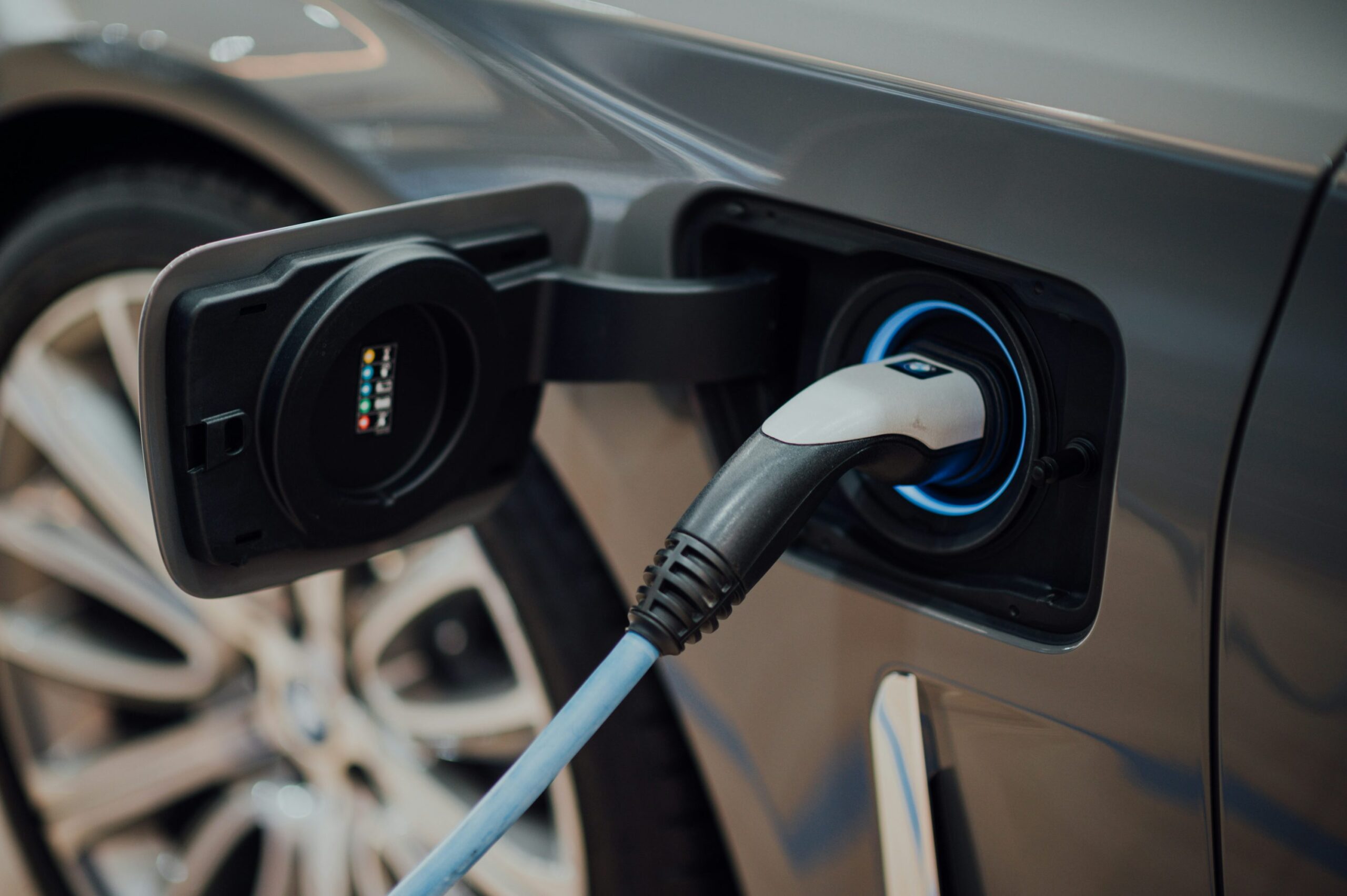 Electric vehicle fast charging cable plugged into a car