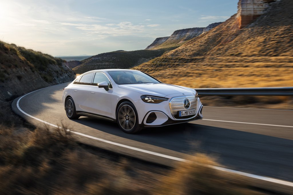 Mercedes-Benz C400 electric sedan driving on a mountain road