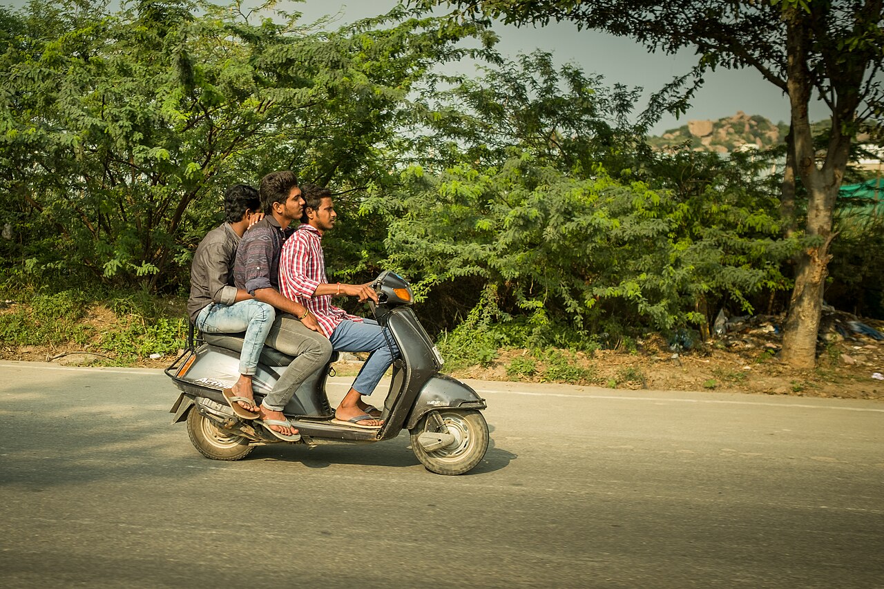 Riders on a two-wheeler on an Indian street