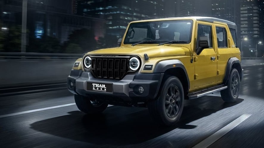 Mahindra Thar Roxx driving through a city at night