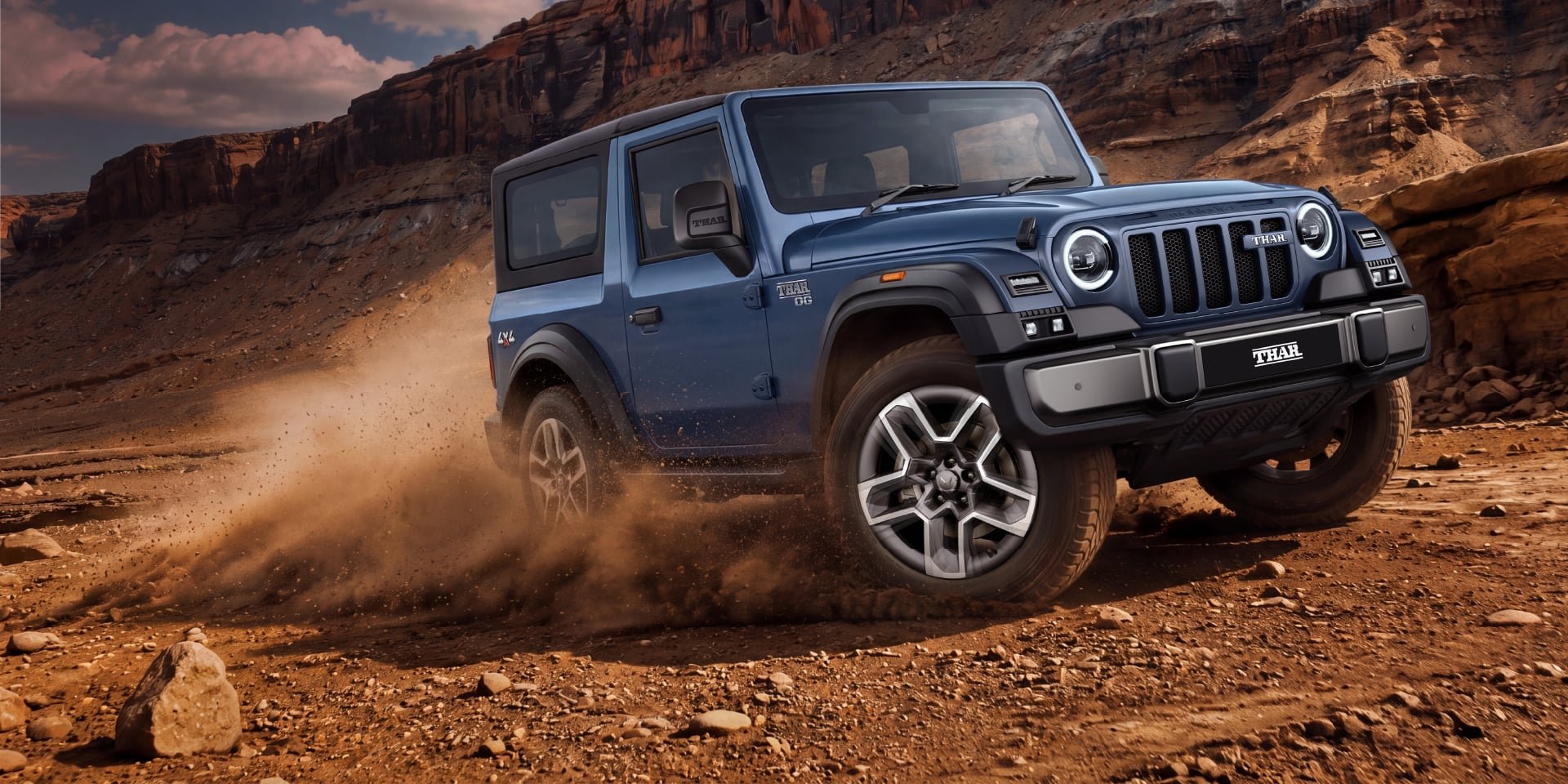 Mahindra Thar OG kicking up dust on an off-road trail