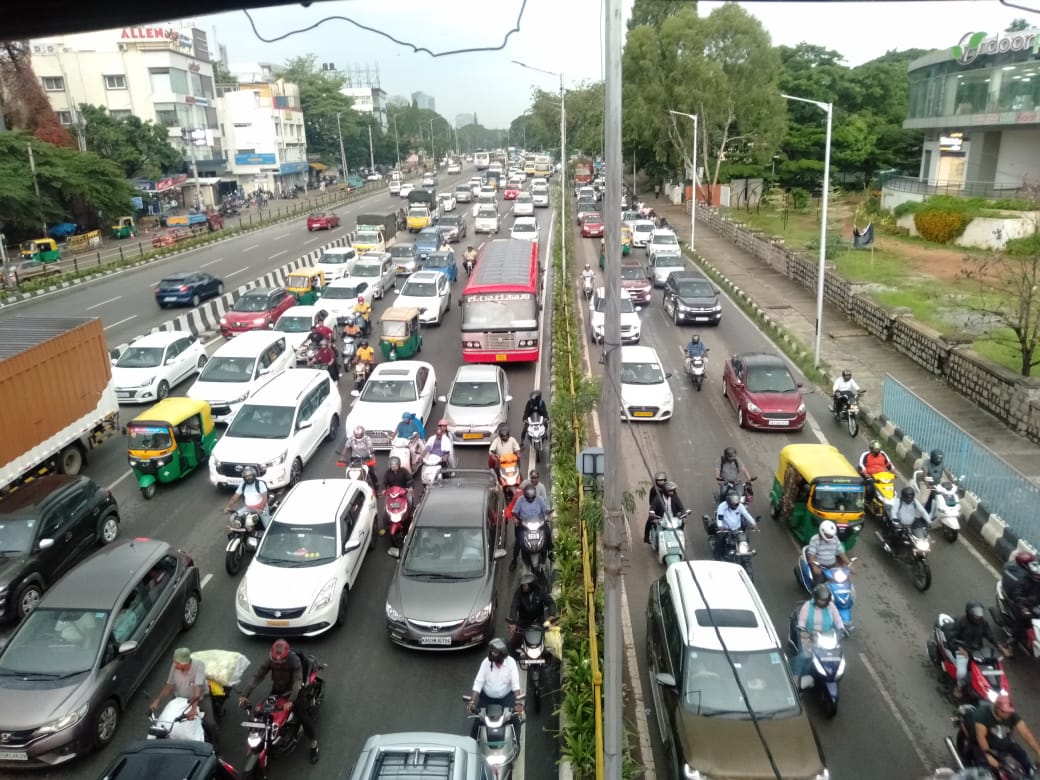 Heavy stop-and-go traffic on an Indian city road with cars, autos and two-wheelers