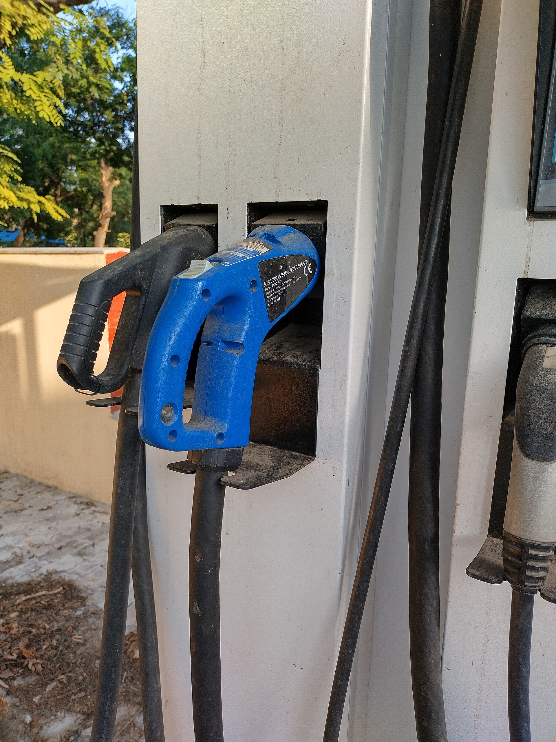 Close-up of two CCS2 electric vehicle charging connectors at an Indian charging station
