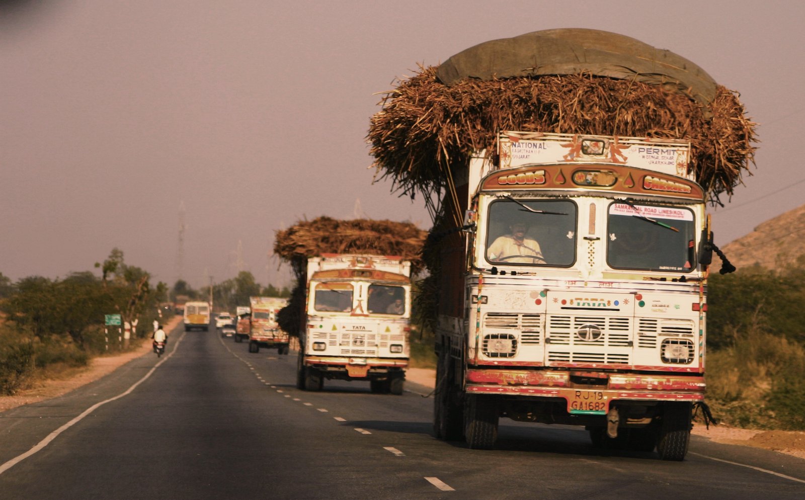 Multiple trucks and cars on an Indian national highway