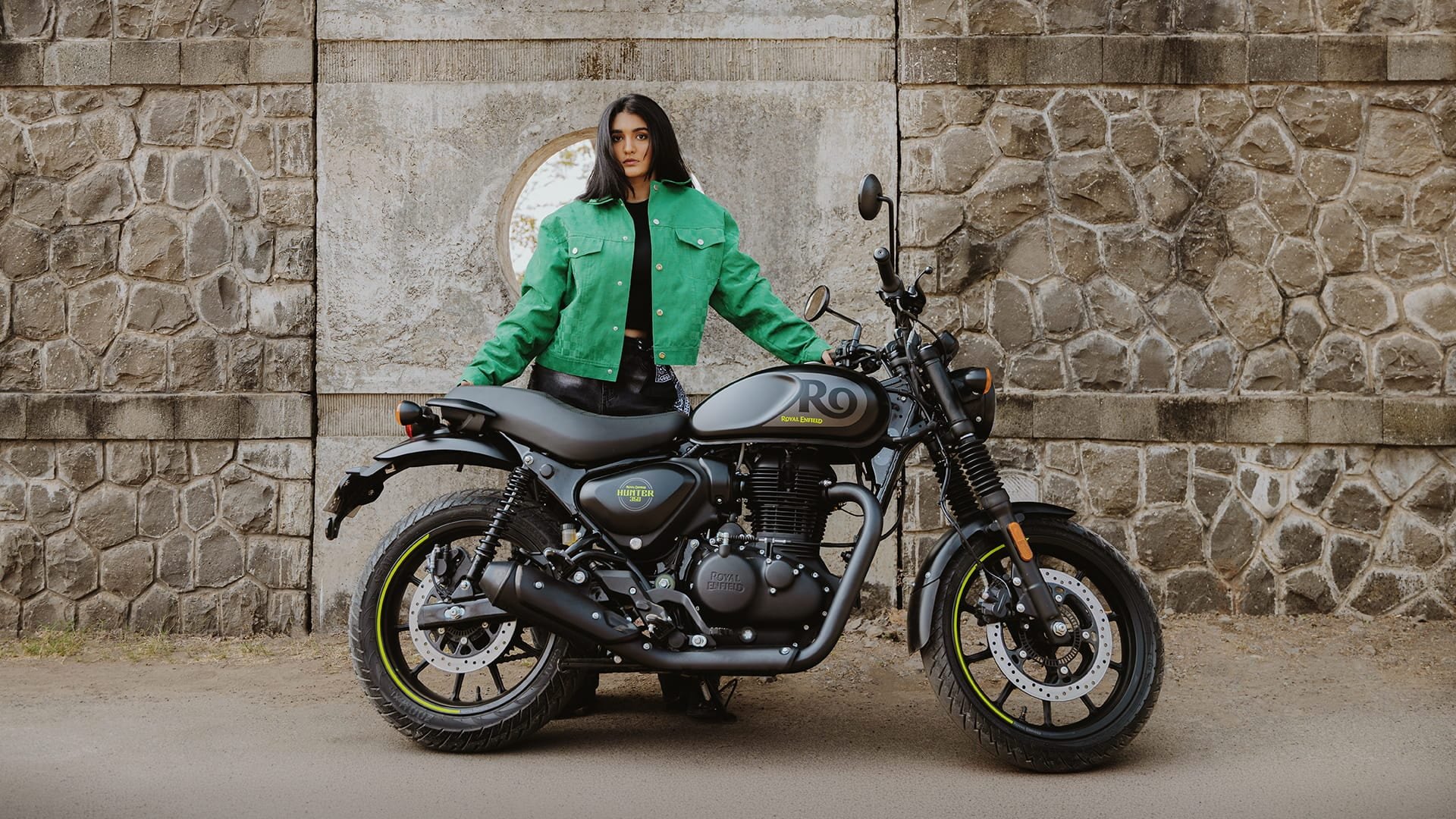 Royal Enfield Hunter 350 parked against a stone wall