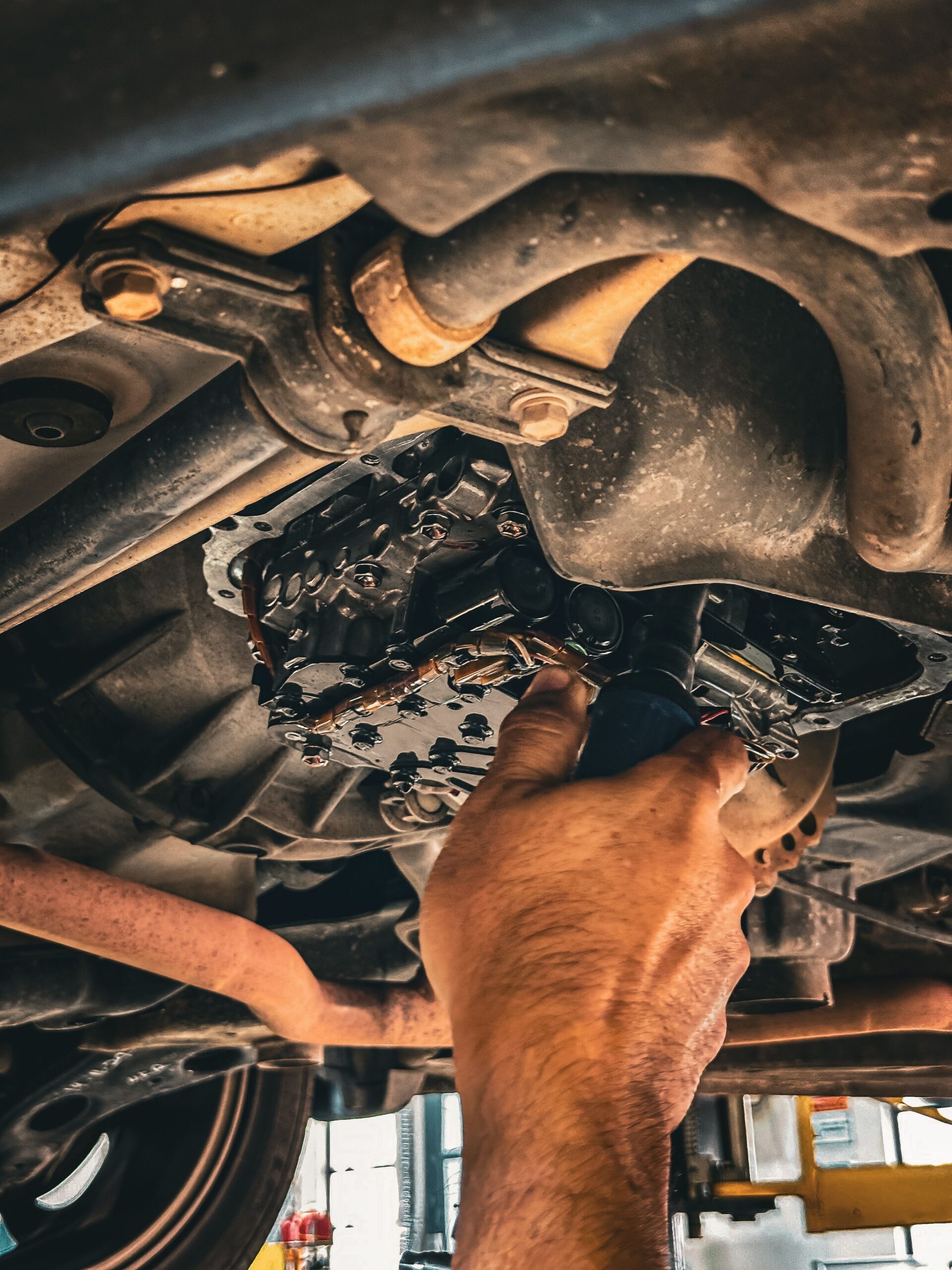 Mechanic working underneath a car during a repair
