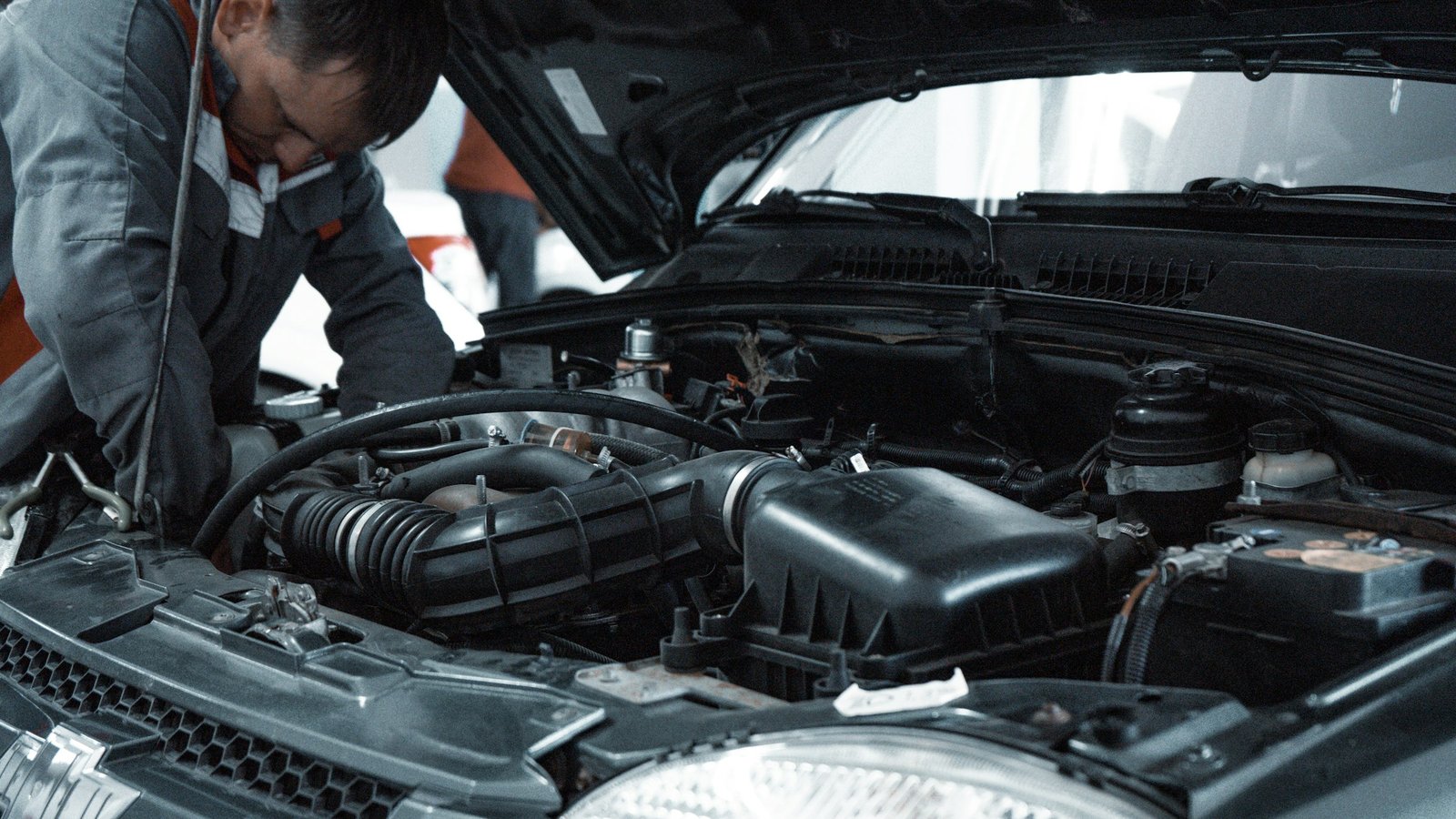 Mechanic inspecting a vehicle during a used-car evaluation