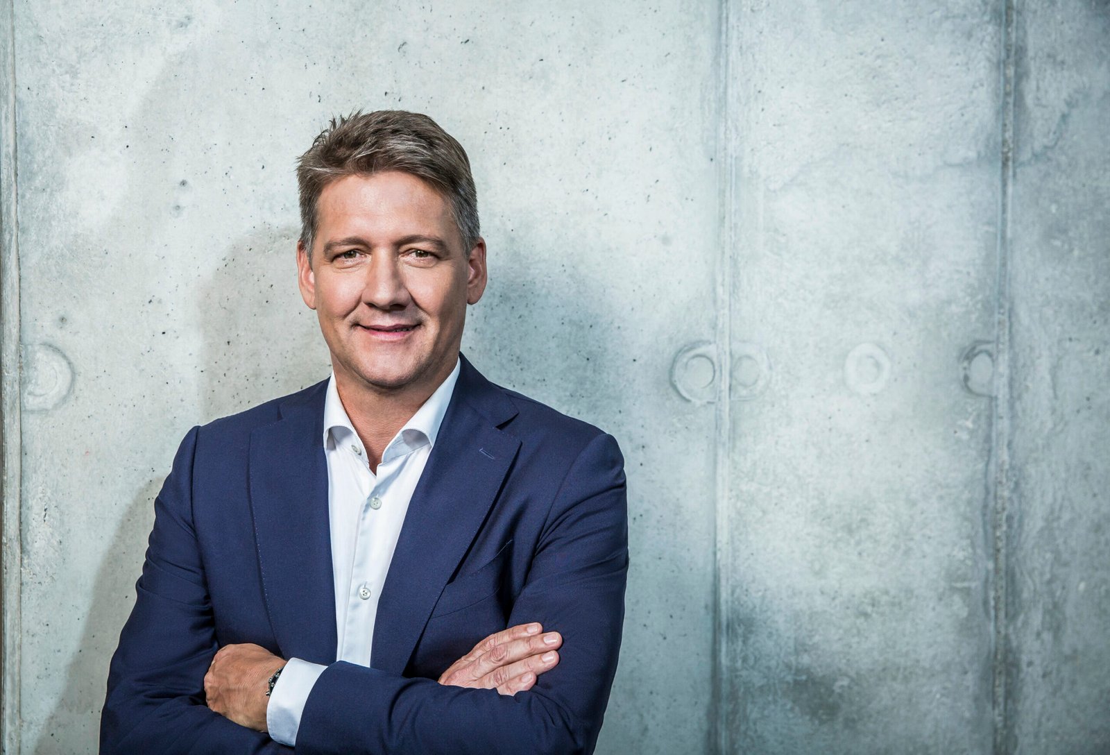 Audi CEO Gernot Dollner portrait against a concrete wall