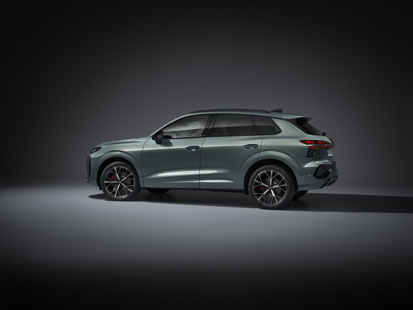 New Audi Q3 side profile studio shot showing the roofline and rear spoiler