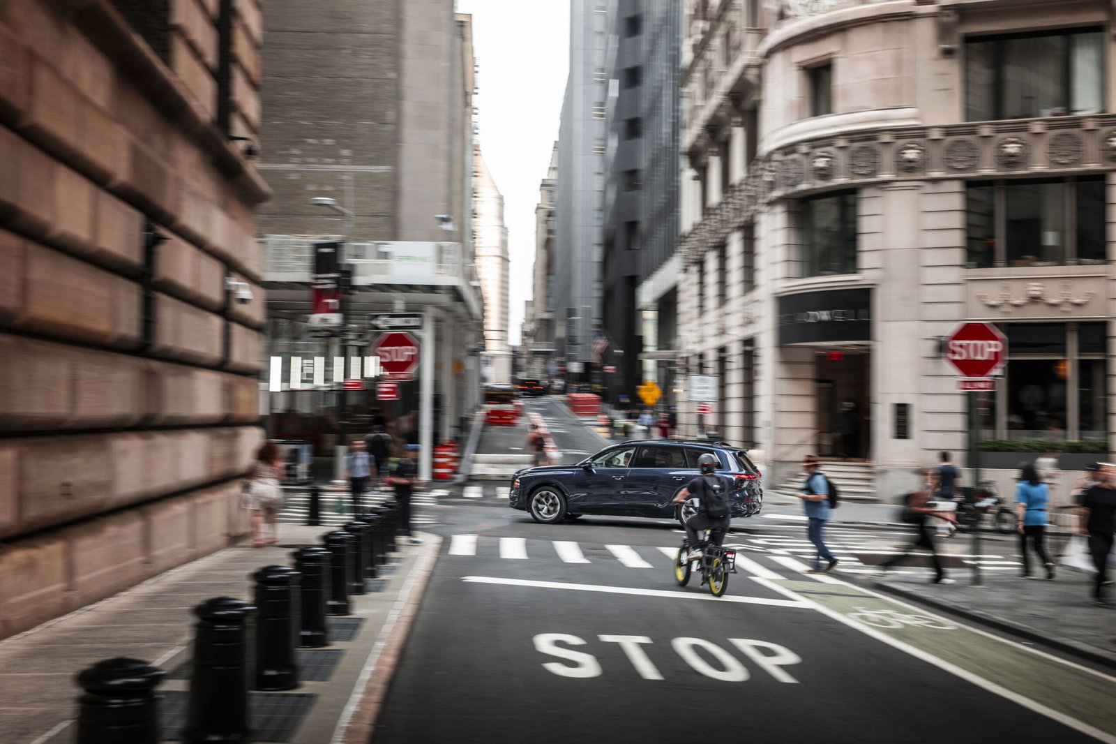 Audi Q9 SUV driving through a New York City street