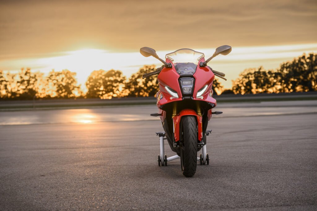 BMW F 450 RR head-on on a paddock stand at sunset
