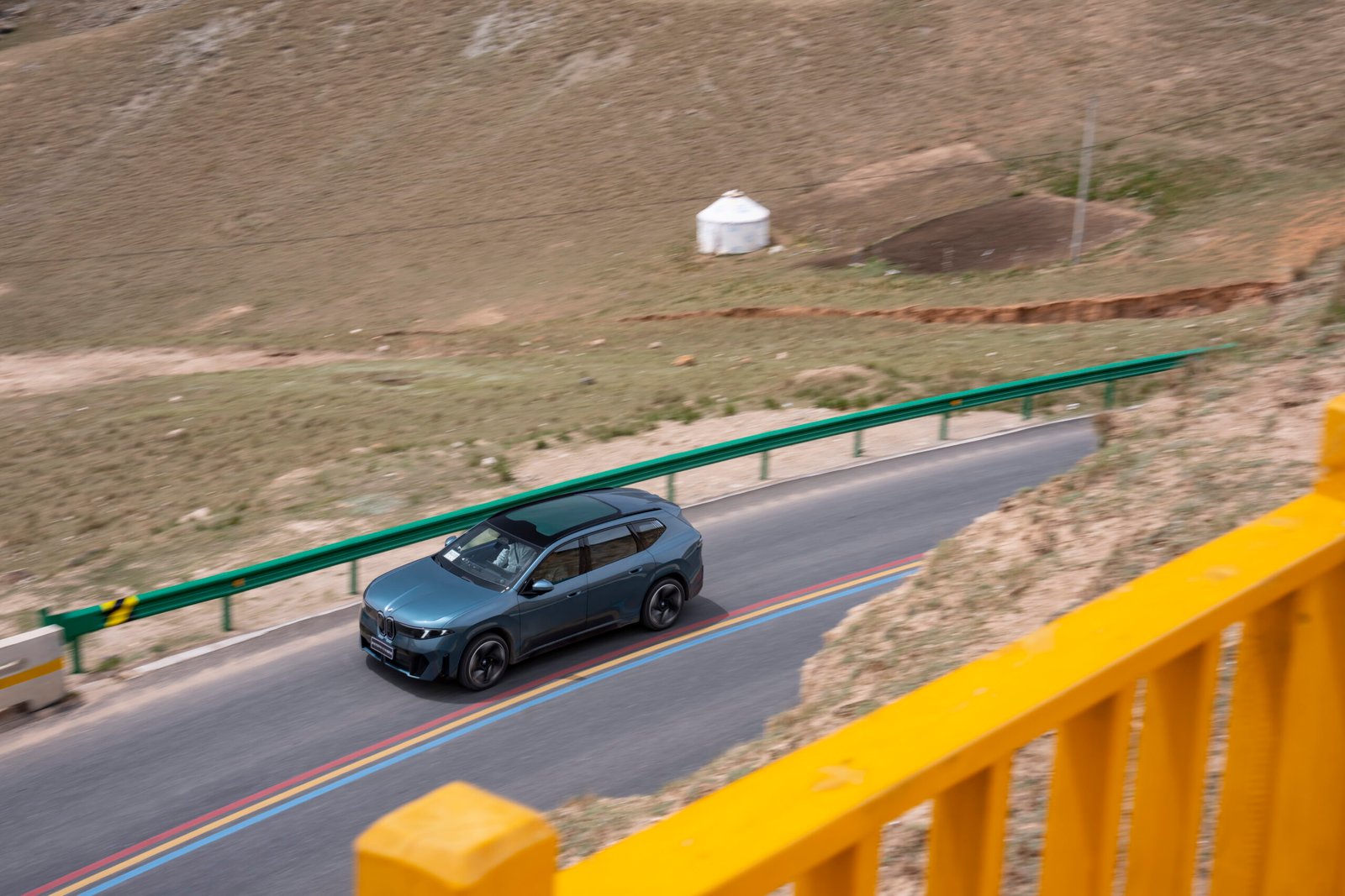 BMW iX3L prototype undergoing testing on a mountain road in China