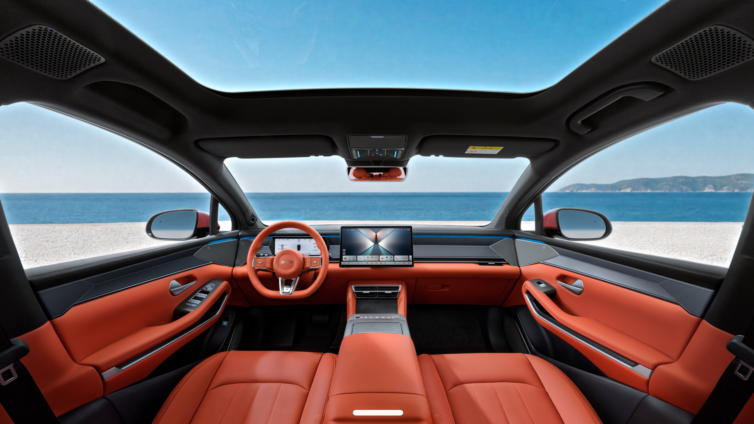 BYD Atto 8 interior showing the orange leather cabin and panoramic glass roof