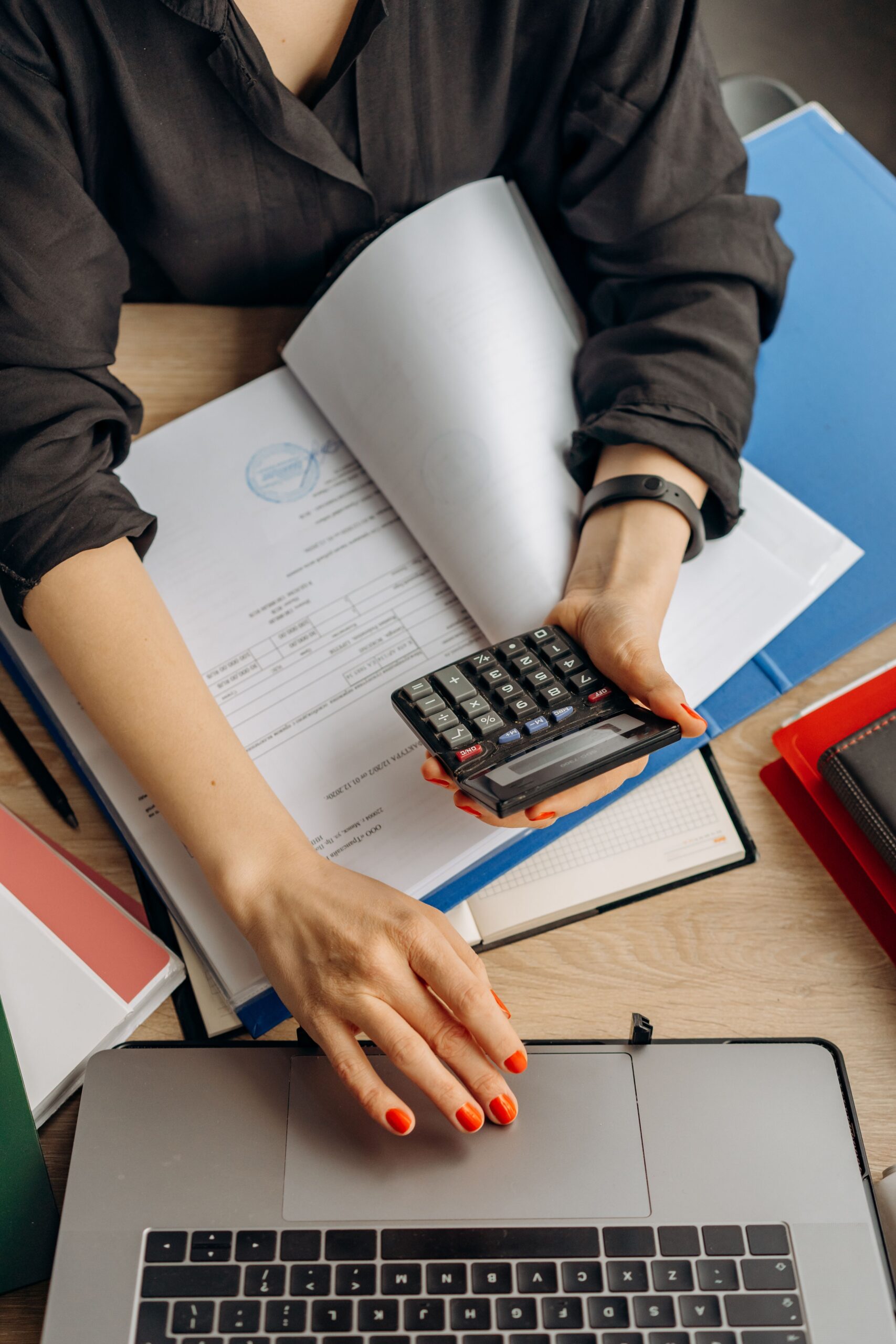 Calculating insurance premium figures with documents and a laptop