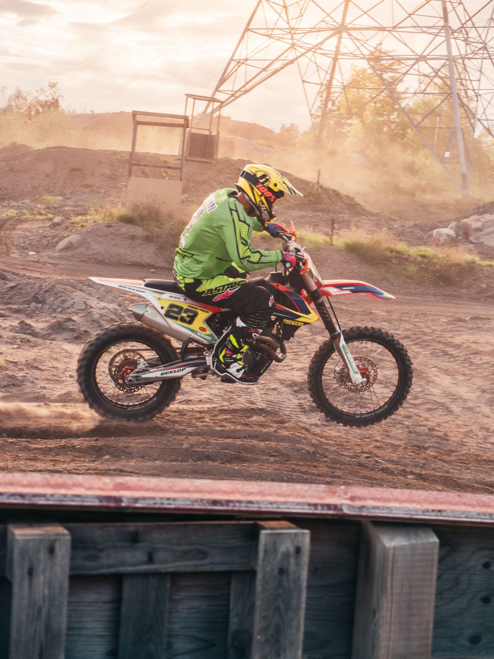 Motocross rider mid-air jump on a dirt bike at sunset