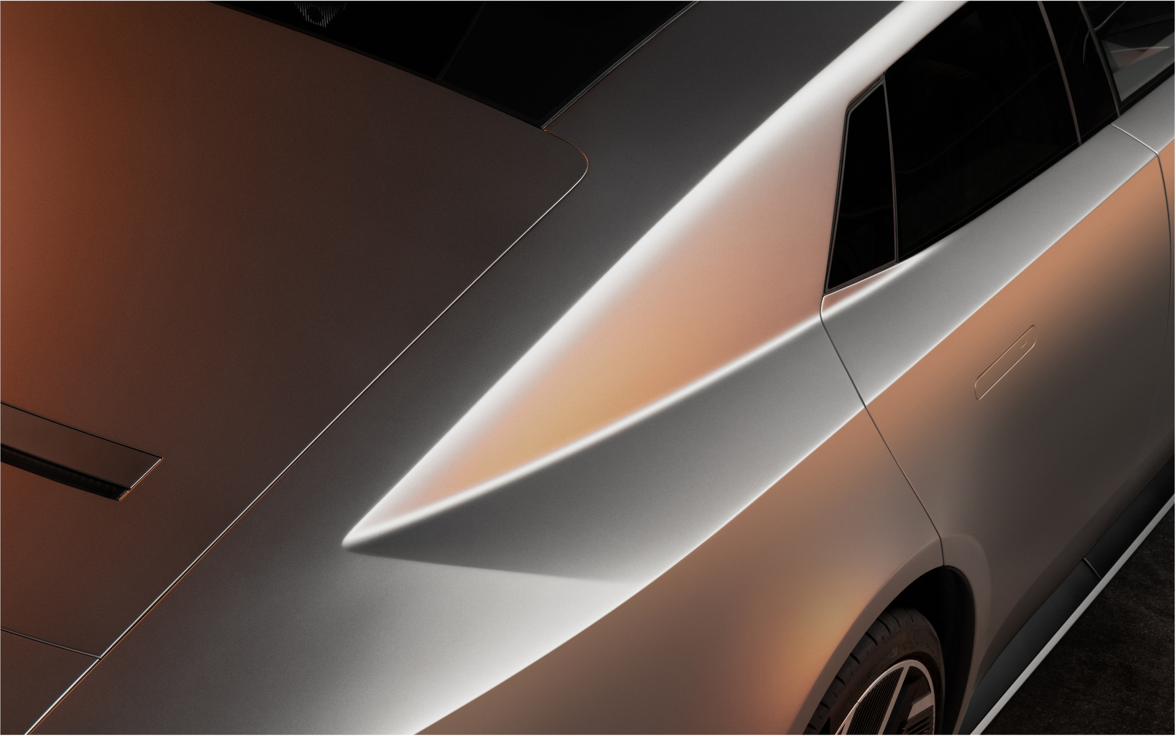 Close-up of the Jaguar Type 01’s rear pillar and body crease in dramatic light