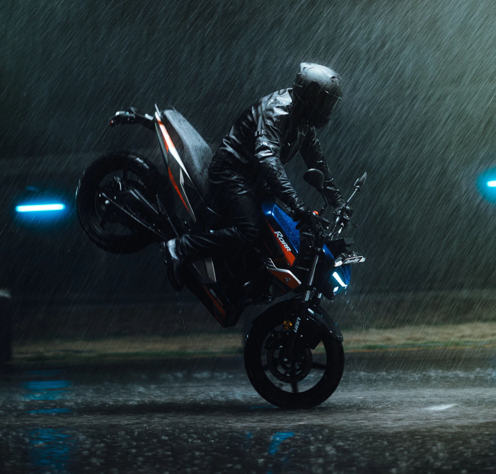 Oben Rorr Evo performing a wheelie on a wet road at night