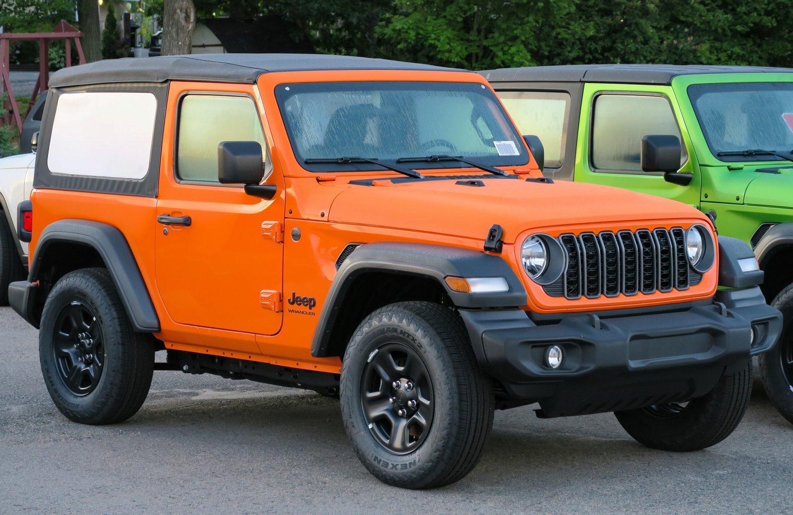 2025 Jeep Wrangler two-door Sport parked on a street