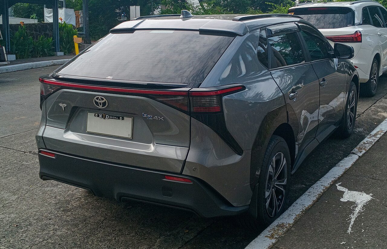 Rear three-quarter view of a Toyota bZ4X electric SUV parked on a street