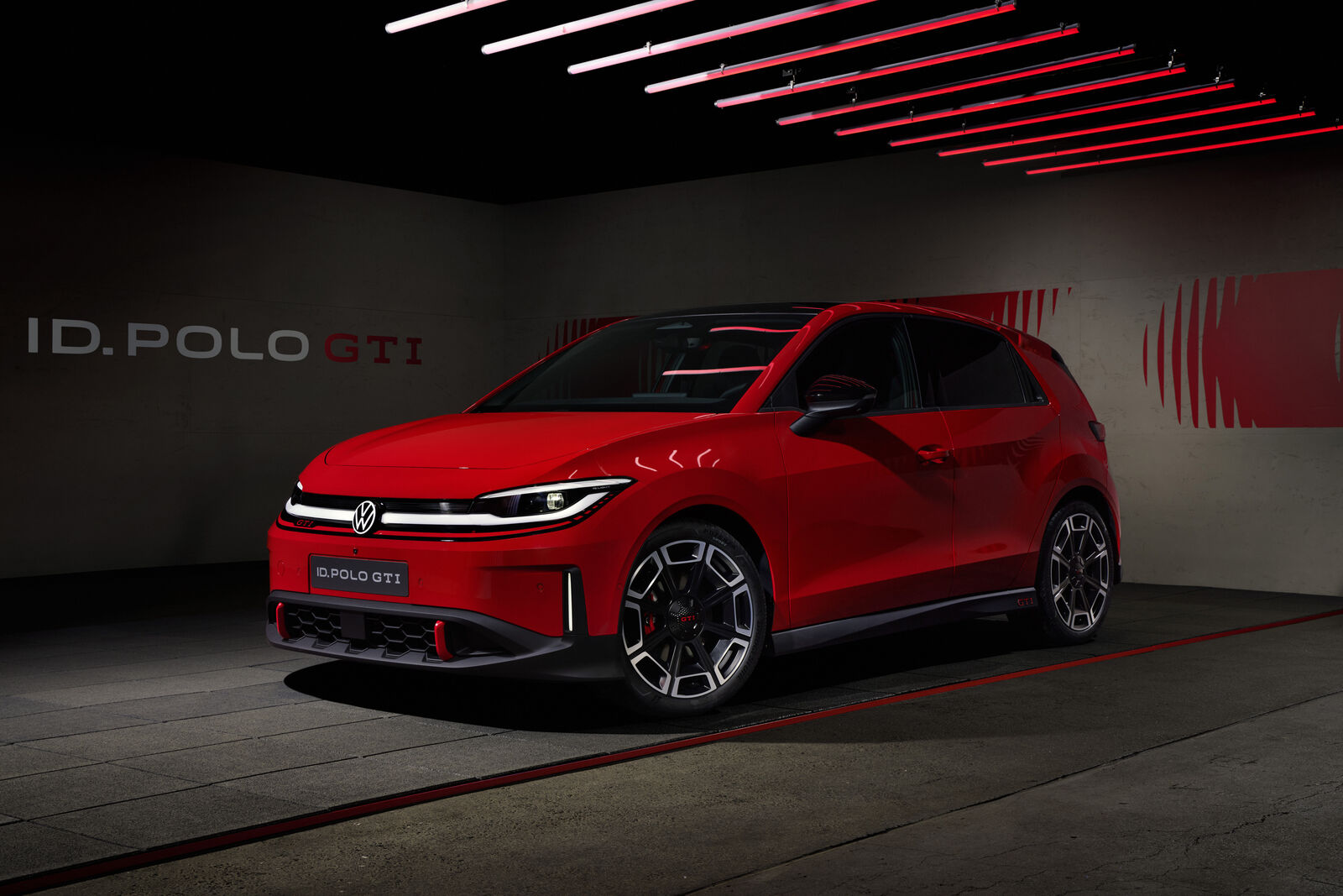 Volkswagen ID. Polo GTI three-quarter front studio shot showing the GTI front grille stripe
