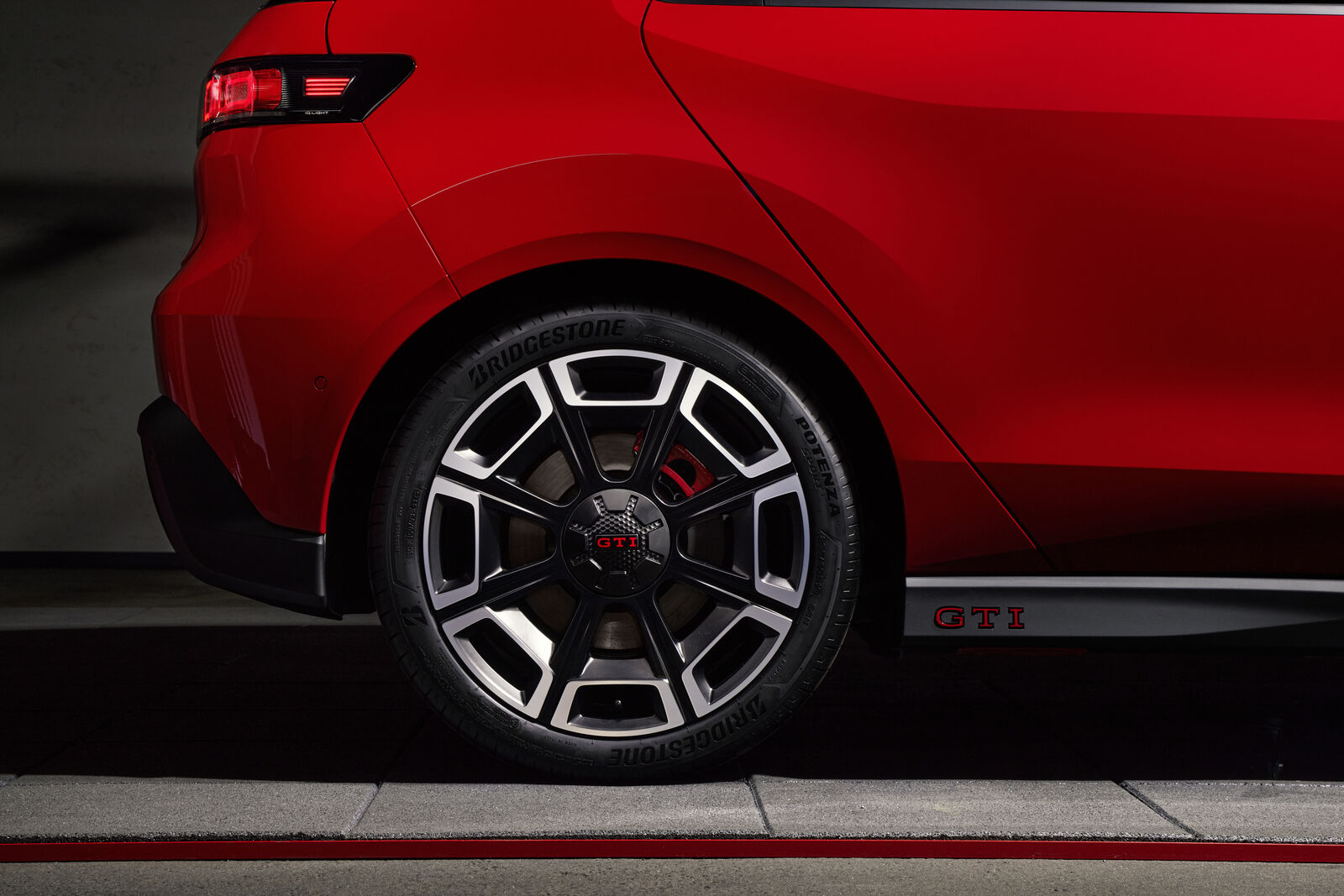 Close-up of the Volkswagen ID. Polo GTI alloy wheel and GTI badge on the side skirt