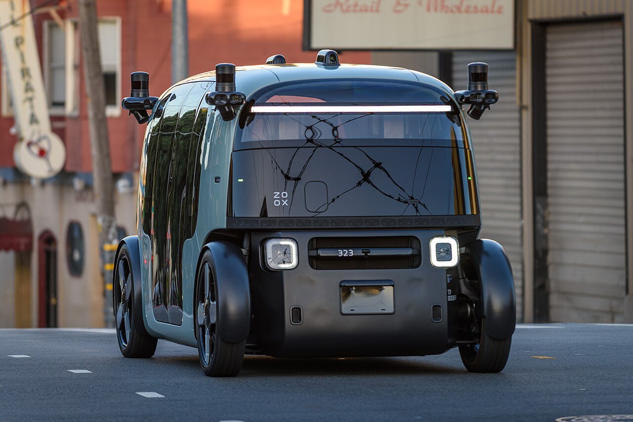 Zoox robotaxi with no steering wheel driving on a city street